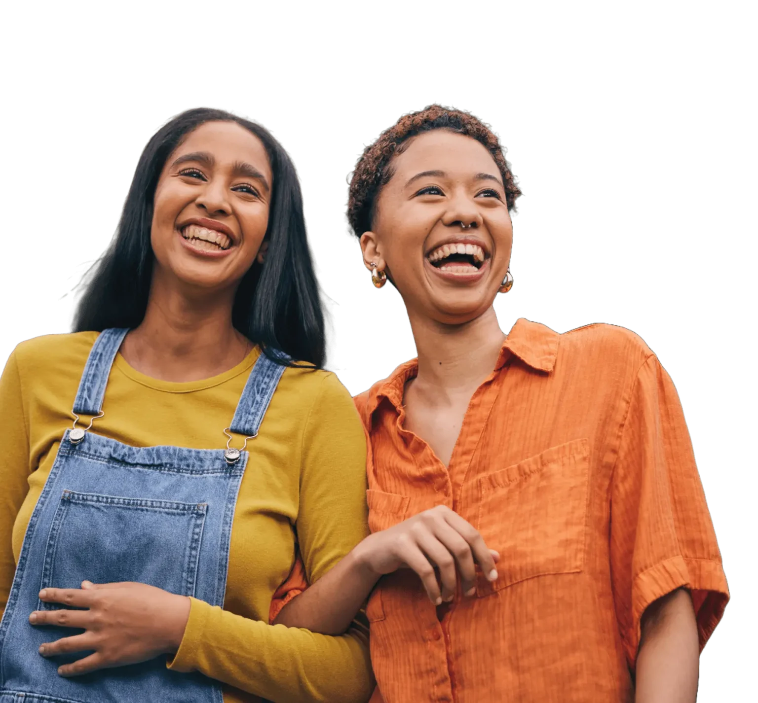 Cutout of two young friends walking arm-in-arm laughing against a transparent background