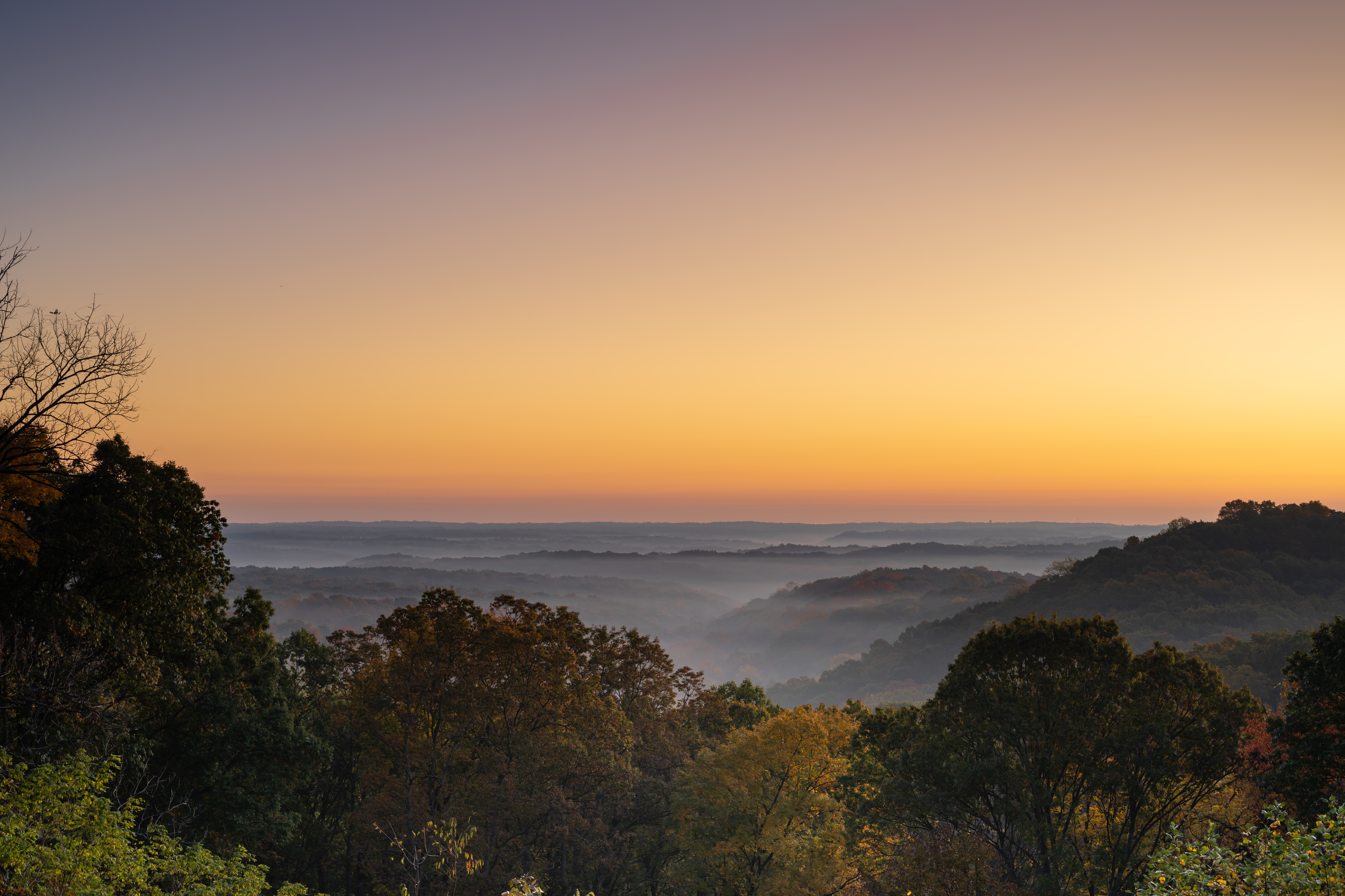 Early morning mist in an October morning as the sun rises at Brown County State Park in Indiana