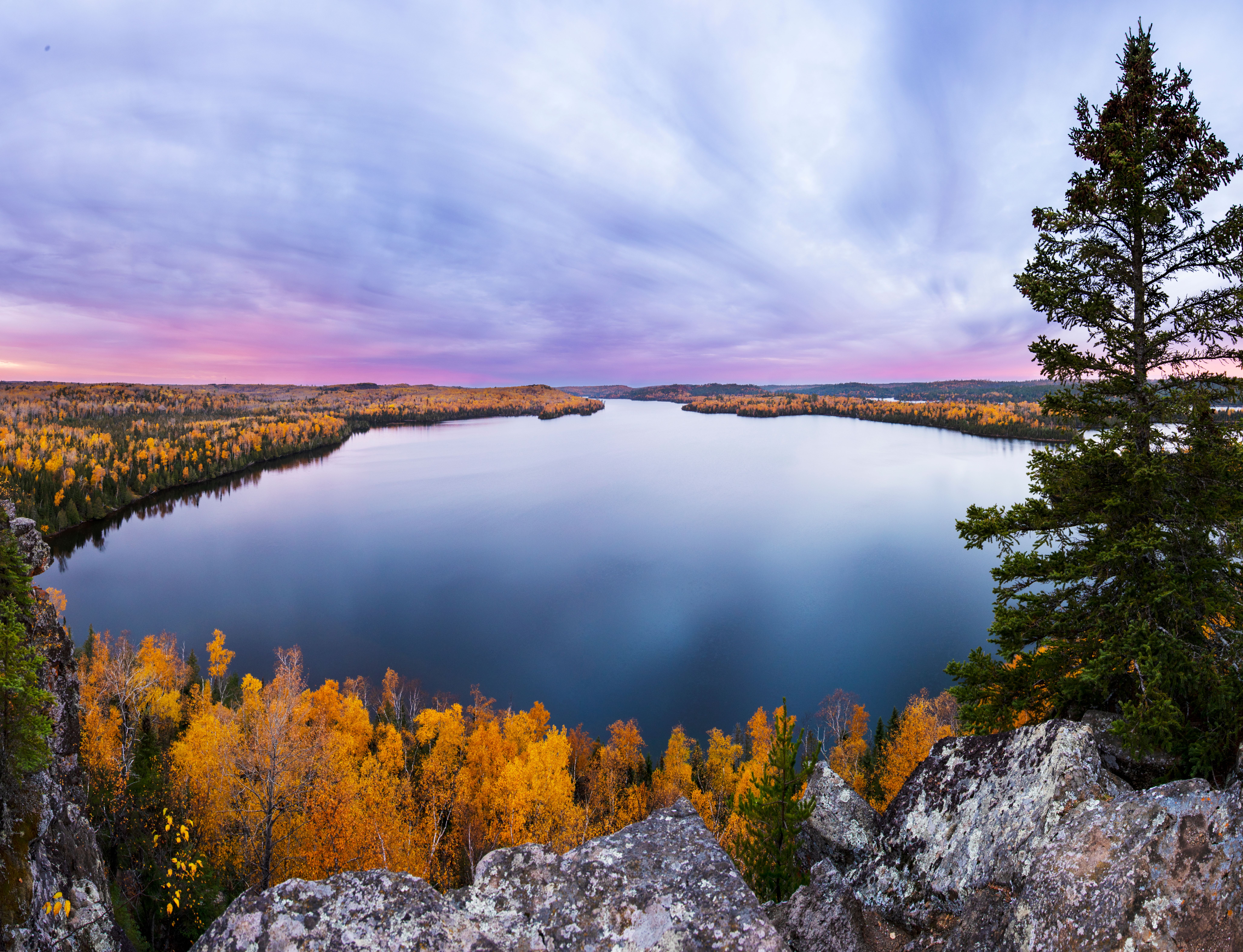 A beautiful fall sunrise from the Honeymoon Bluff overlooking Hungry Jack Lake and peak fall colors in northern Minnesota