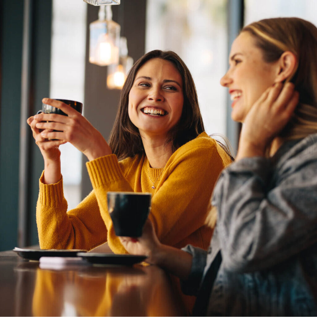 Two young women in cafe having coffee